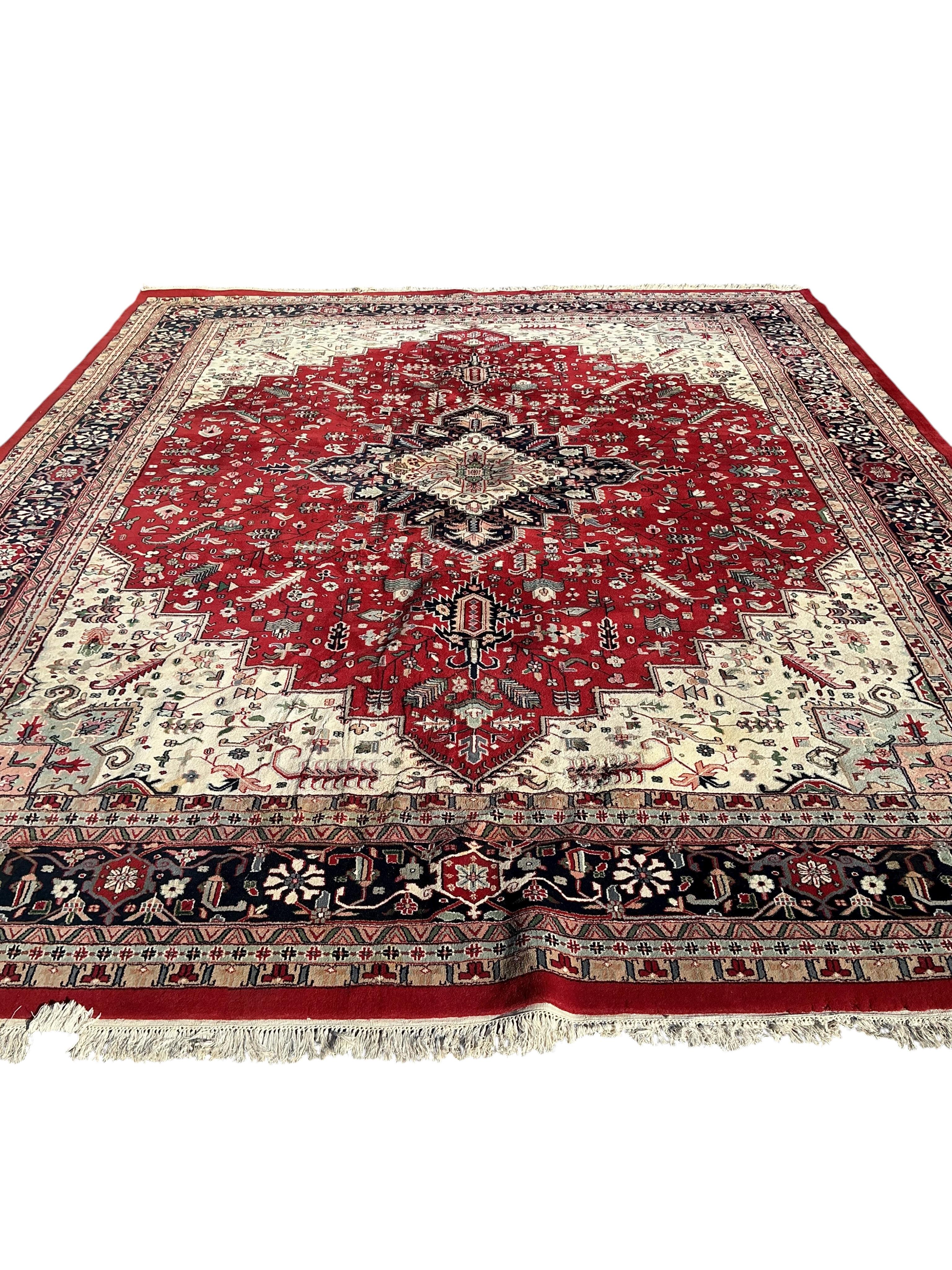 A Heriz red ground carpet, (some old moth damage, now inactive) 455 x 362cm